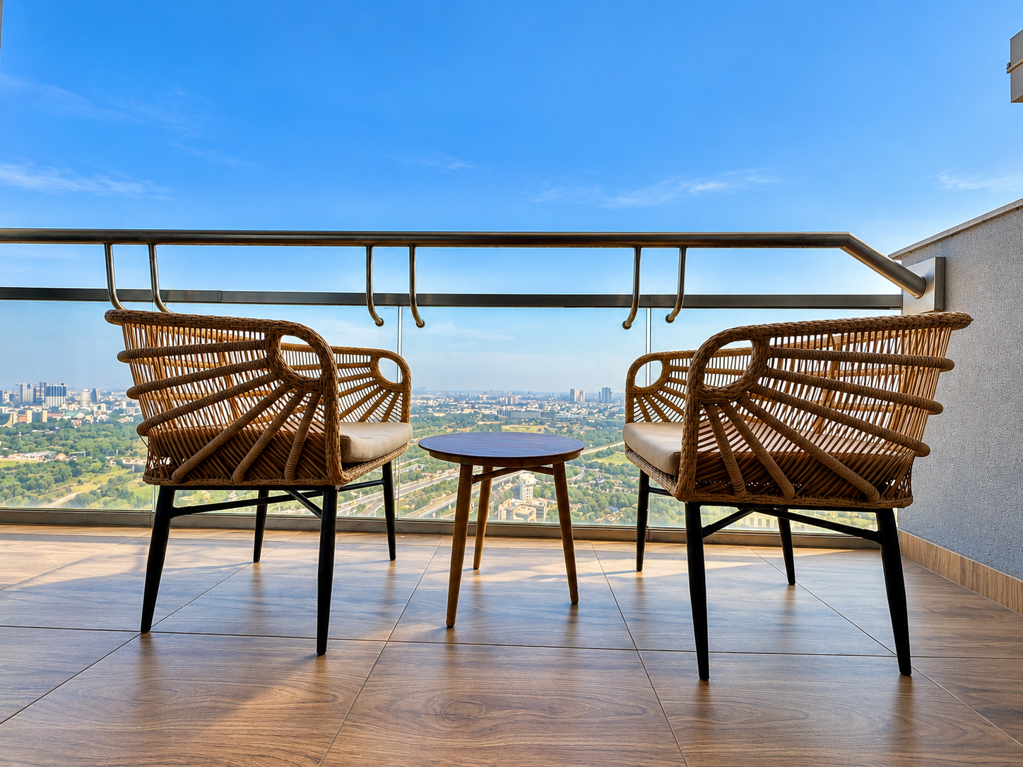 Rattan chairs and round table on the open balcony at Panorama Balcony 32, Supernova Noida