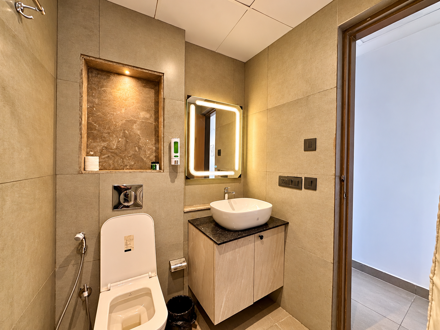 Marble vanity with vessel sink at Panorama Balcony 32 service apartment, Noida