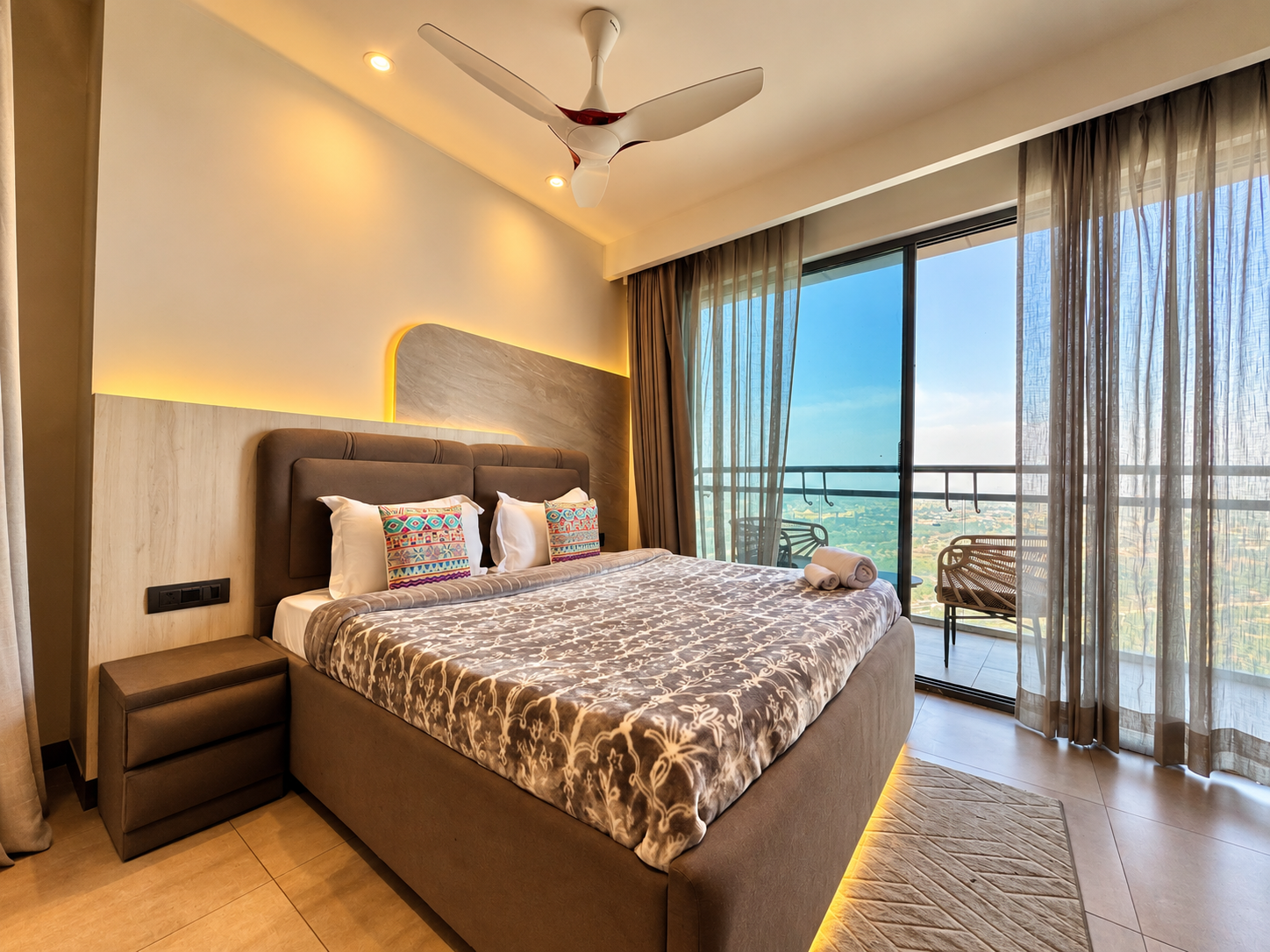 Bedroom with sheer curtains and greenery view at Panorama Balcony 32, Supernova Noida Airbnb