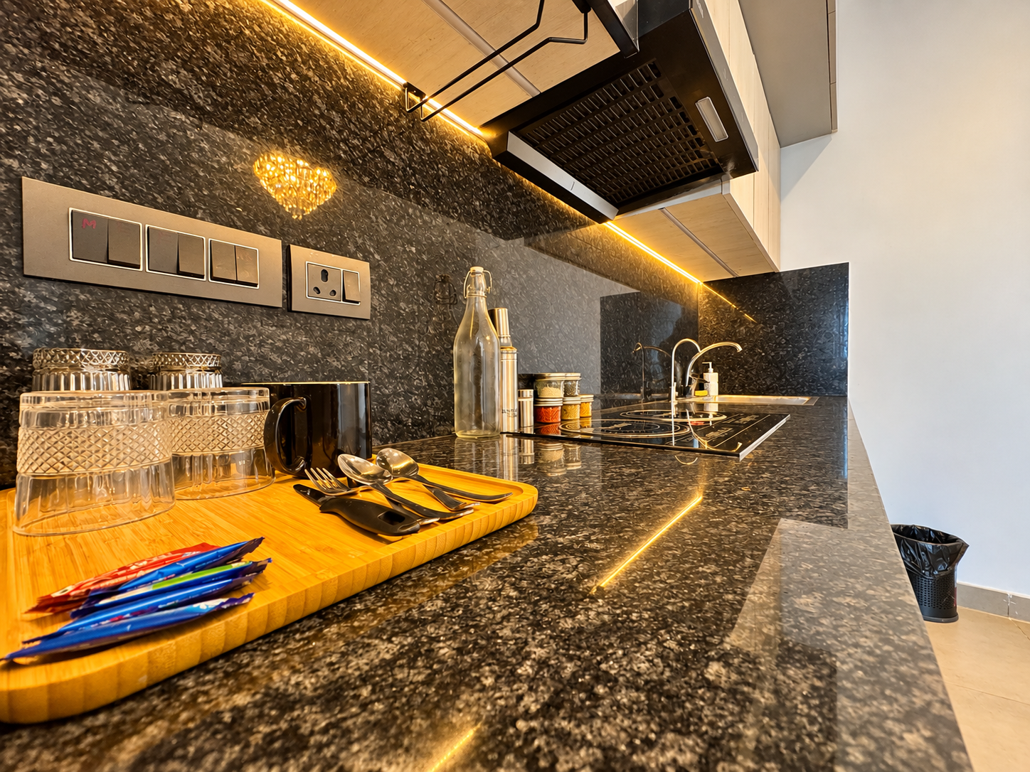 Kitchen with granite countertop and induction hob at Panorama Balcony 32, Supernova room price from ₹3,500