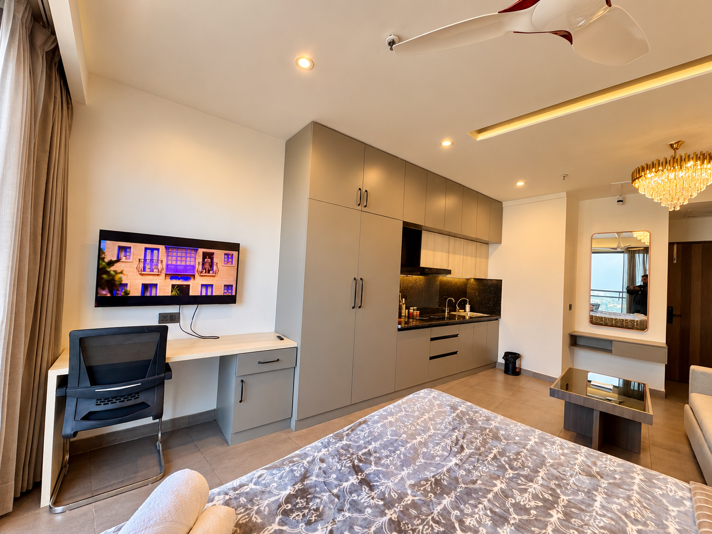 TV desk, wardrobe and mirror in the studio at Panorama Balcony 32, stay in Supernova Noida
