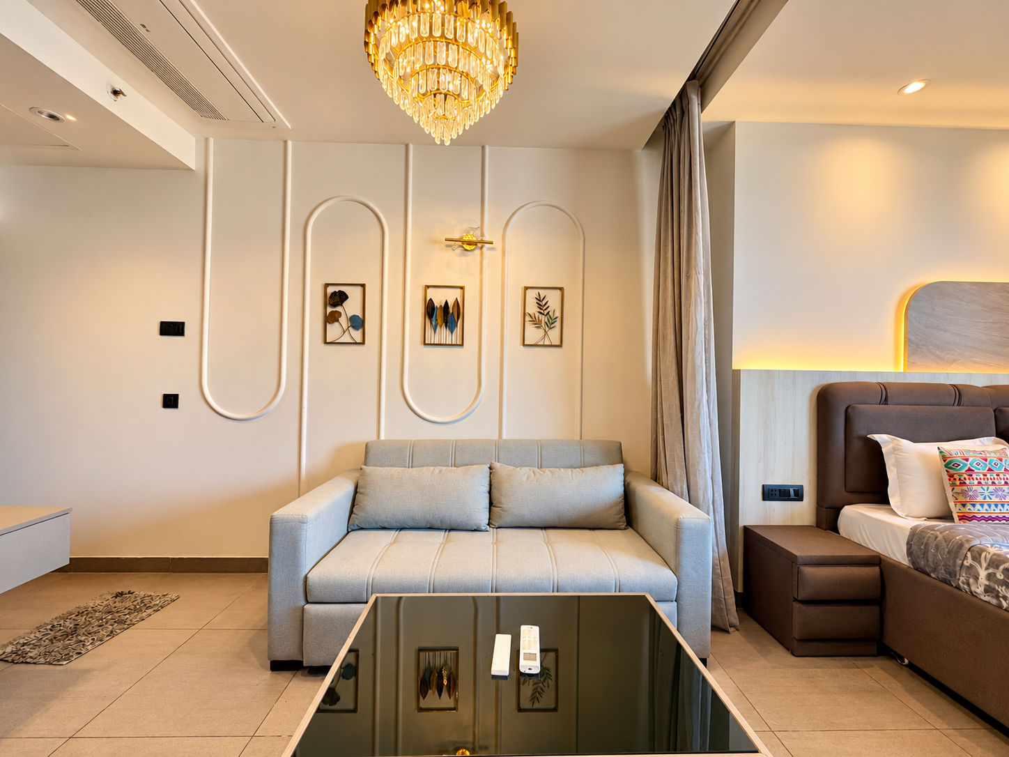 Studio with TV unit, wardrobe, bed and kitchenette at Panorama Balcony 32, service apartment in Noida