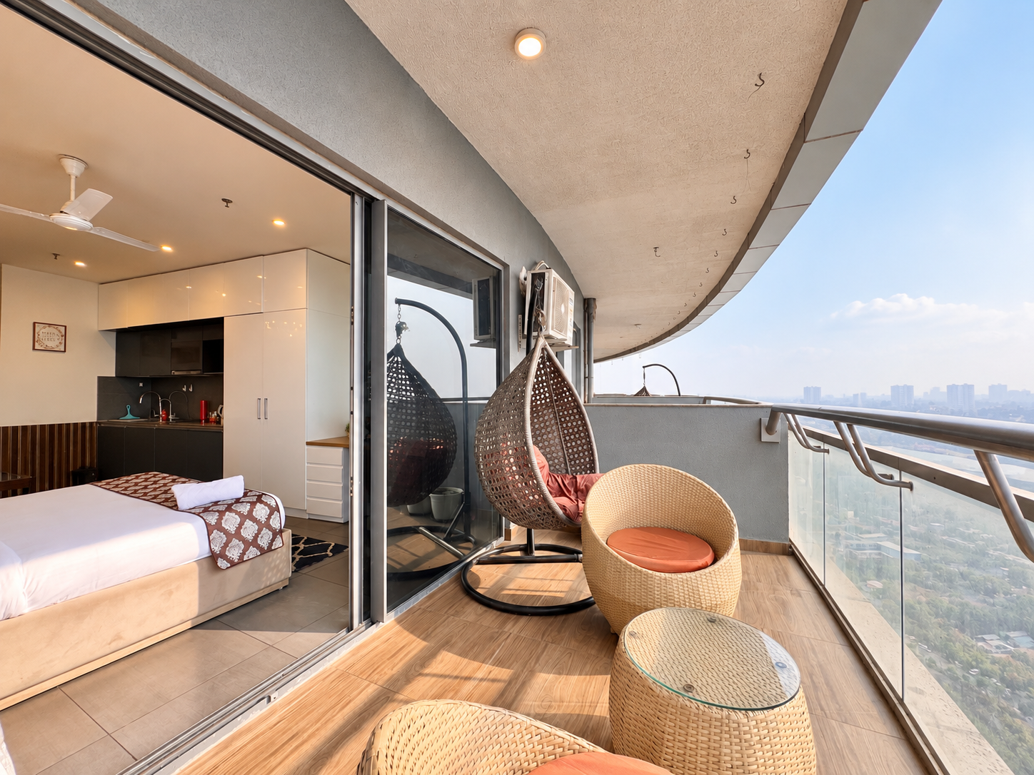 Balcony swing chairs with river view at RiverCrest 39, Supernova Spira Airbnb in Noida