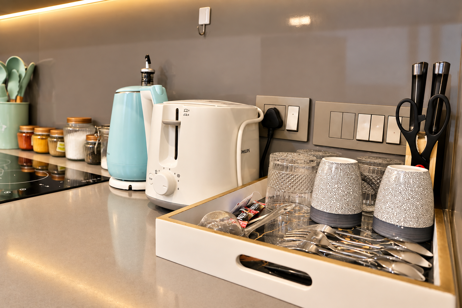 Kitchenette tray with glasses and cutlery at RiverCrest 39, Supernova Spira Noida