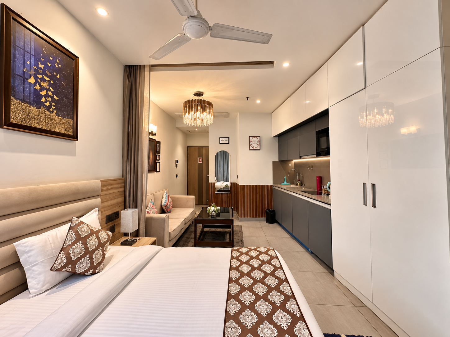Open-plan studio bedroom and kitchen view at RiverCrest 39 service apartment, Noida