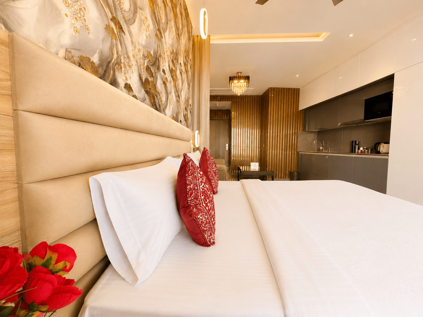 Dark-luxe king bed with kitchenette behind at UrbanAura Studio 37, Supernova Spira Airbnb
