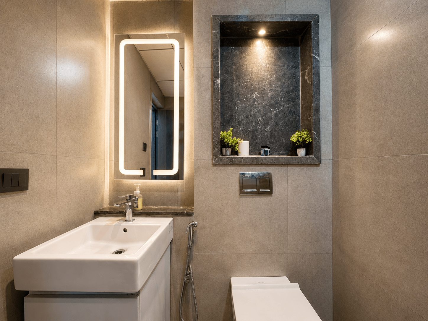 Modern bathroom with LED mirror at UrbanAura Studio 37, Supernova Spira Noida