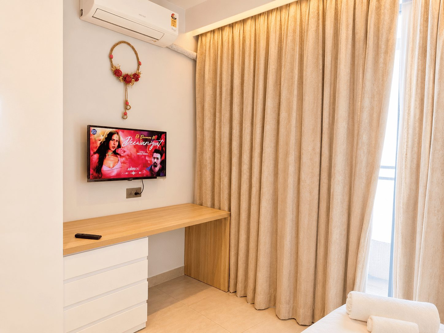Smart TV and work desk at UrbanAura Studio 37, stay in Supernova Noida with WiFi