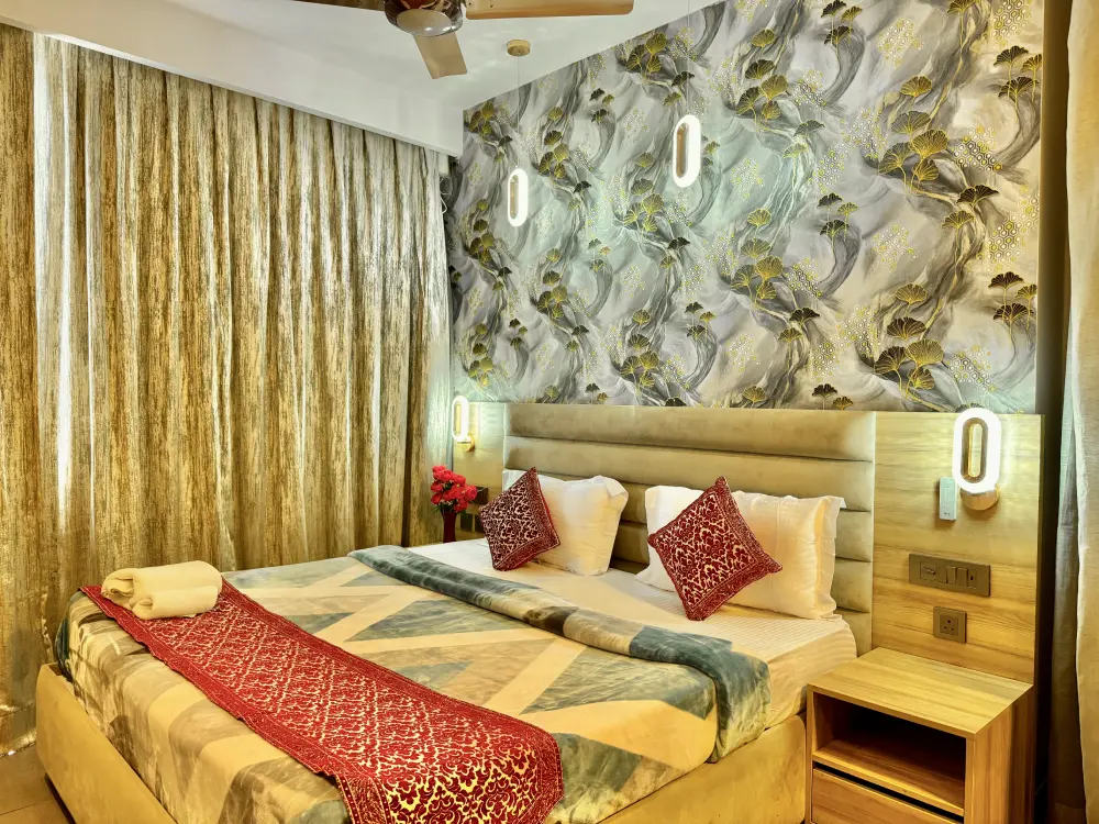 Bedroom with gold wallpaper at Mulberry Homes Supernova Noida