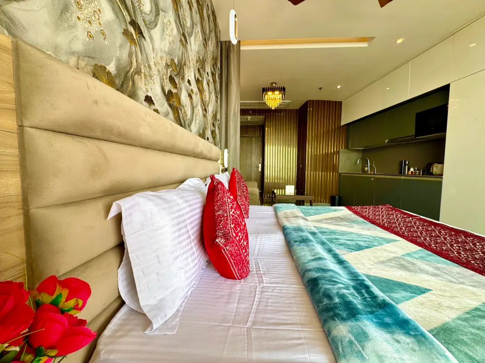 Bedroom with red accent wall at Mulberry Homes Supernova Noida