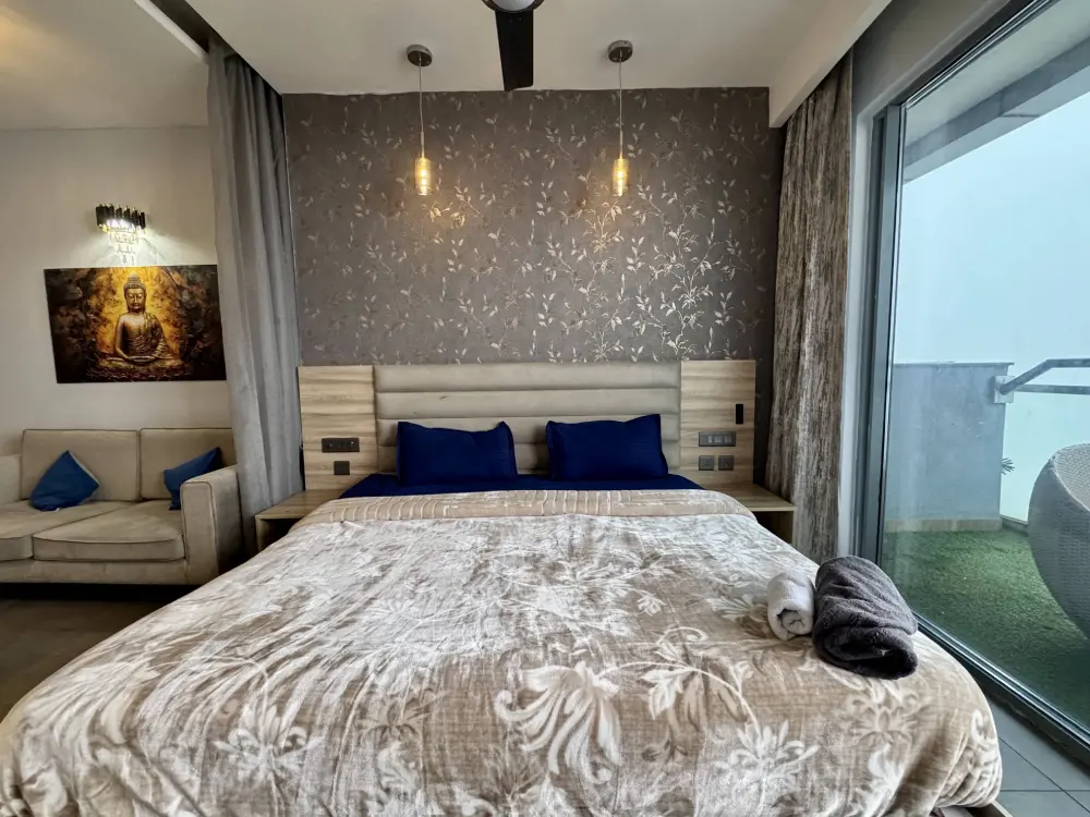 cozy bedroom with blue accent in CityGlow 28 Mulberry Homes Noida