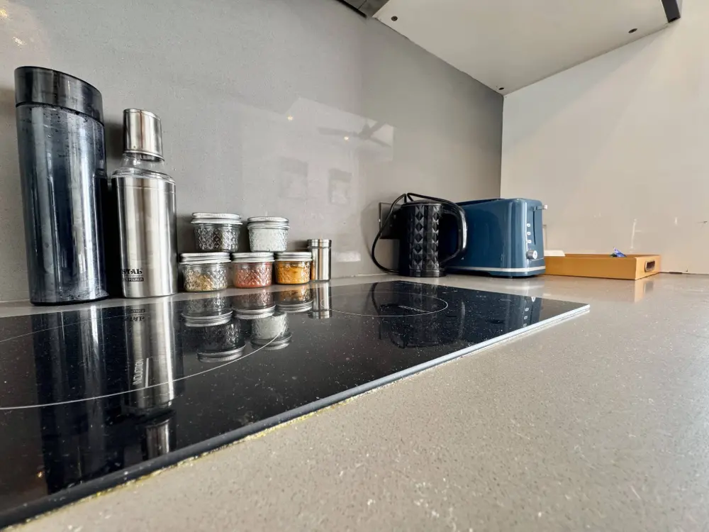 open kitchen with dark cabinets in RiverEase 29 Supernova Noida