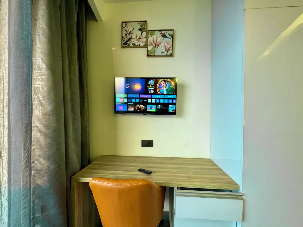bedroom with smart TV and wall art in Panorama 32 Mulberry Homes Noida