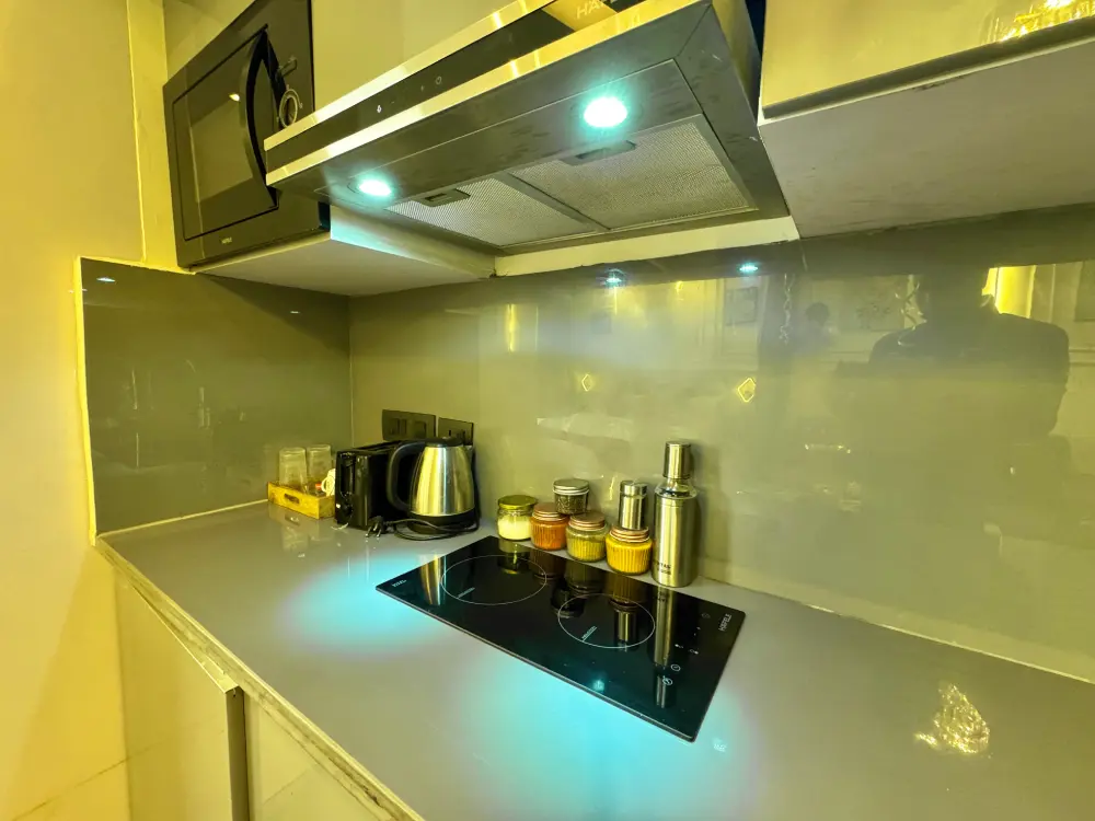 modern kitchen with yellow accents in Panorama 32 Mulberry Homes Noida