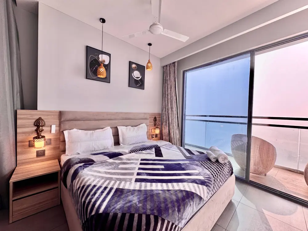 Bedroom with large window view at Mulberry Homes Supernova Noida