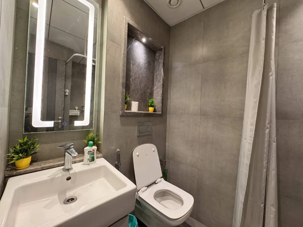 Bathroom vanity with mirror at Mulberry Homes Supernova Noida