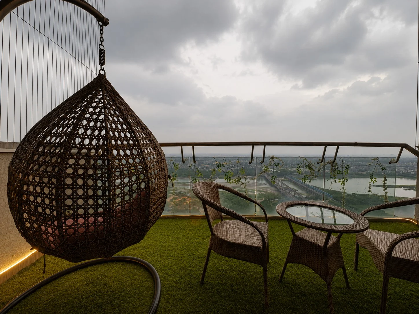 Balcony swing chair with river view at SkyRiver 43, Supernova Spira Airbnb in Noida