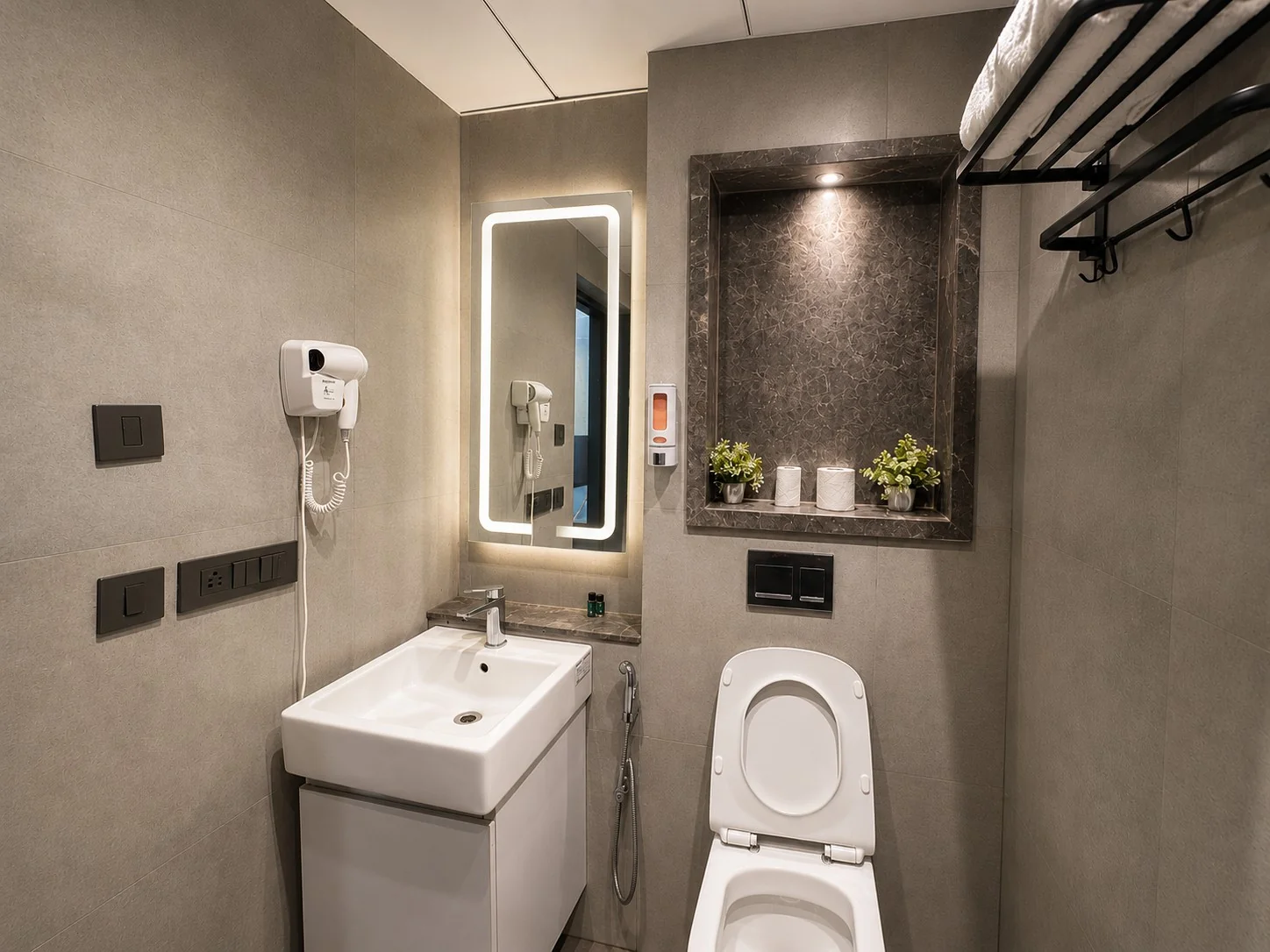 Hotel-style bathroom with LED mirror and vanity at SkyRiver 43, Supernova Noida