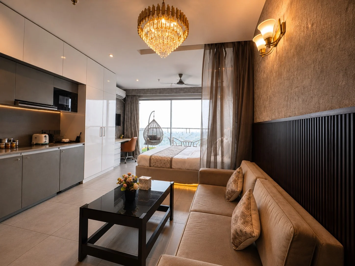 Studio bed, sofa and kitchenette opening to the balcony at SkyRiver 43, Supernova Spira room booking