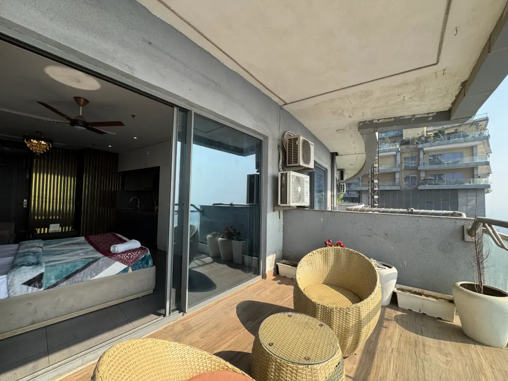 Luxury bedroom in UrbanAura 37 river view studio apartment in Supernova Noida