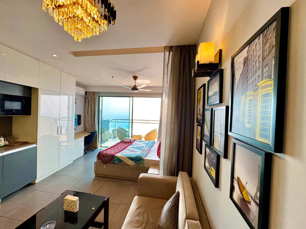 Modern studio apartment interior with wardrobe and TV at UrbanAura 37 Noida