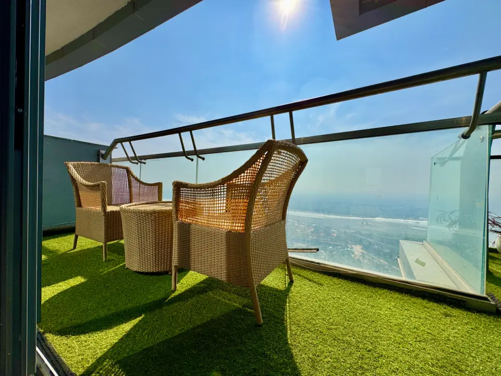 Eleve 31 balcony with swing chair and grass turf at Supernova Spira Noida river view apartment