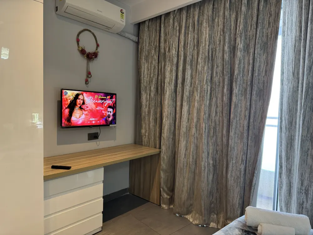 Bedroom with dark curtains at Mulberry Homes Supernova Spira Noida