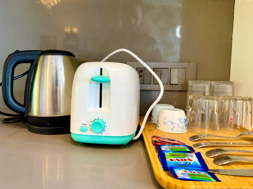 Kitchen with electric kettle and appliances at Mulberry Homes Supernova Noida