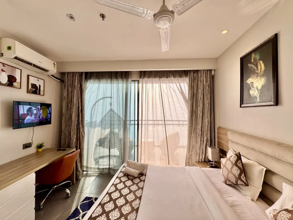 Luxury homestay Noida bedroom TV wall Supernova Spira