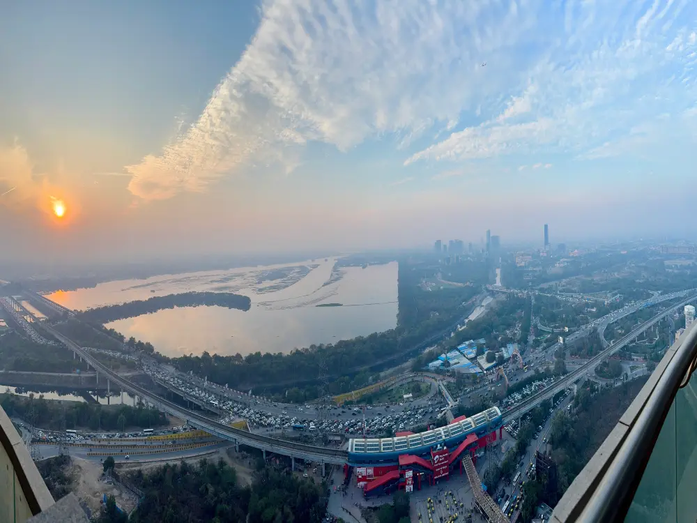 Panoramic sunset view of Yamuna river and Noida city skyline from 39th floor balcony at RiverCrest 39 Supernova Spira