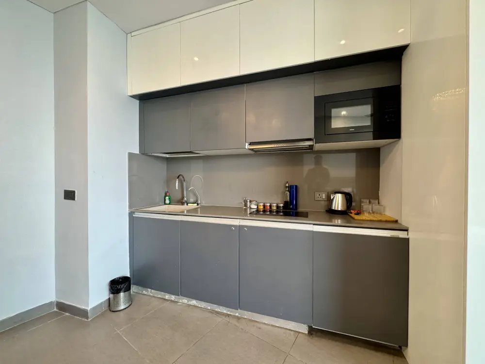 kitchen counter with electric kettle at Supernova Spira luxury stay Noida