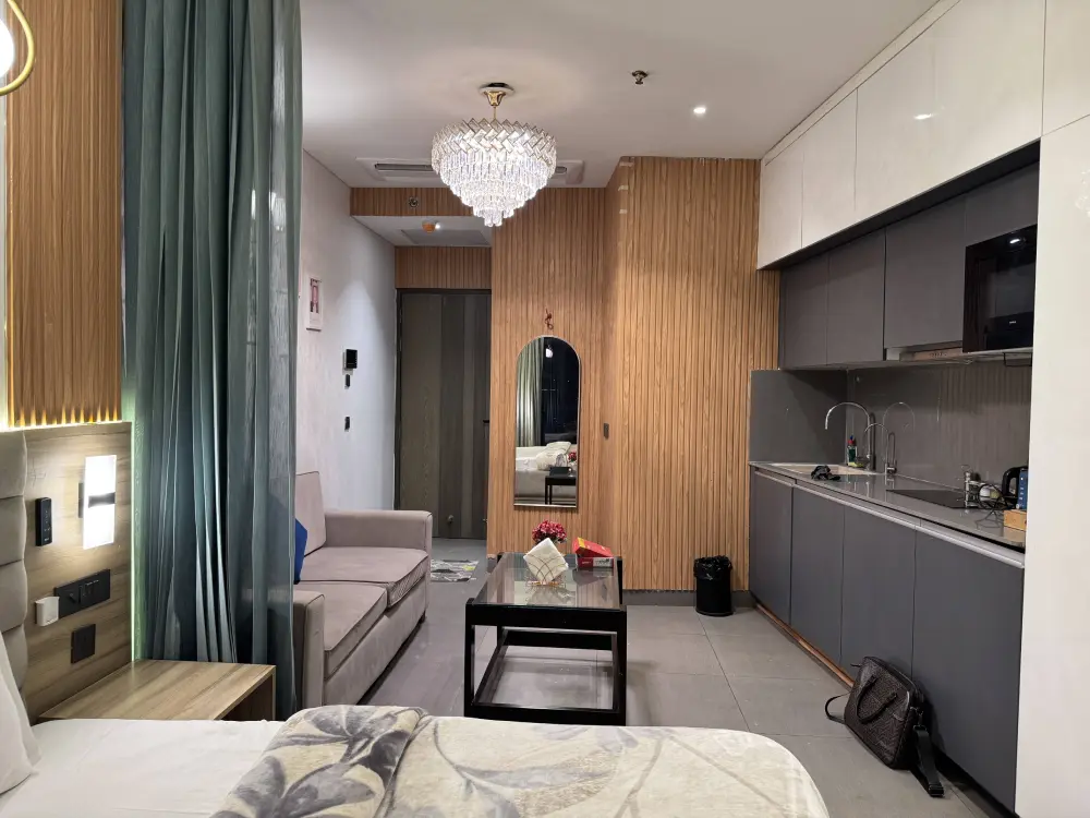 bedroom with chandelier at luxury stay Mulberry Homes Supernova Noida