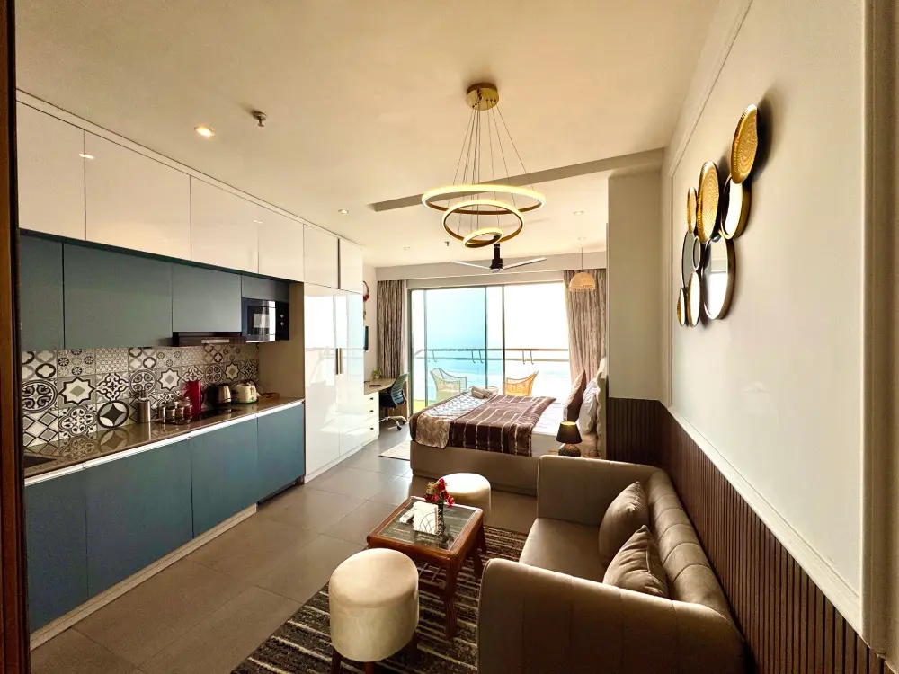 open kitchen with blue cabinets in Eleve 31 Supernova Spira Noida