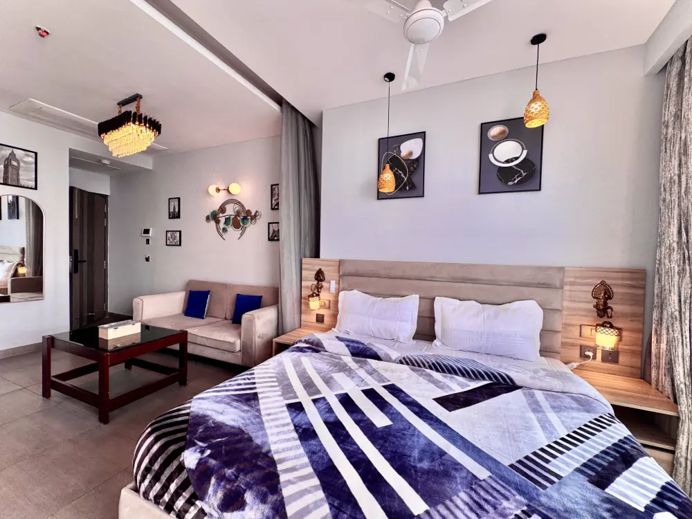 Bedroom with purple decor at Mulberry Homes luxury stay Noida