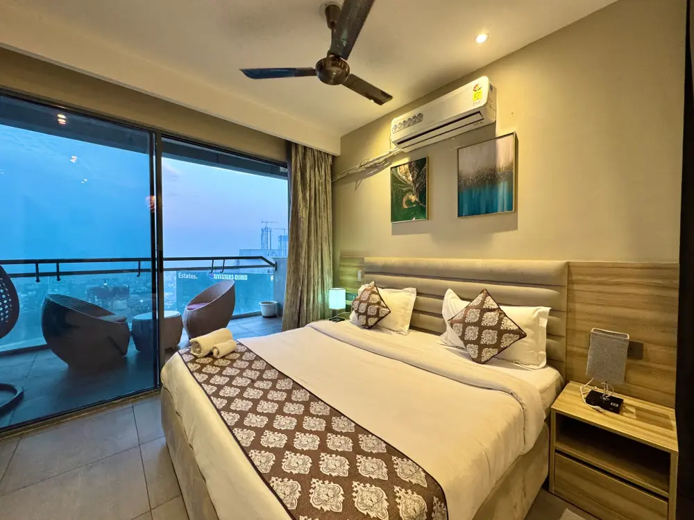 Bedroom with panoramic city view at Mulberry Homes Supernova Noida