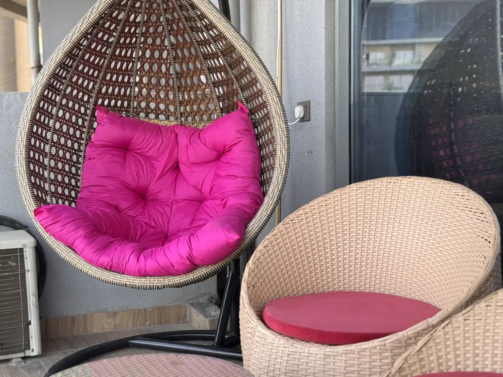 Outdoor swing chair on balcony at Mulberry Homes Supernova Noida