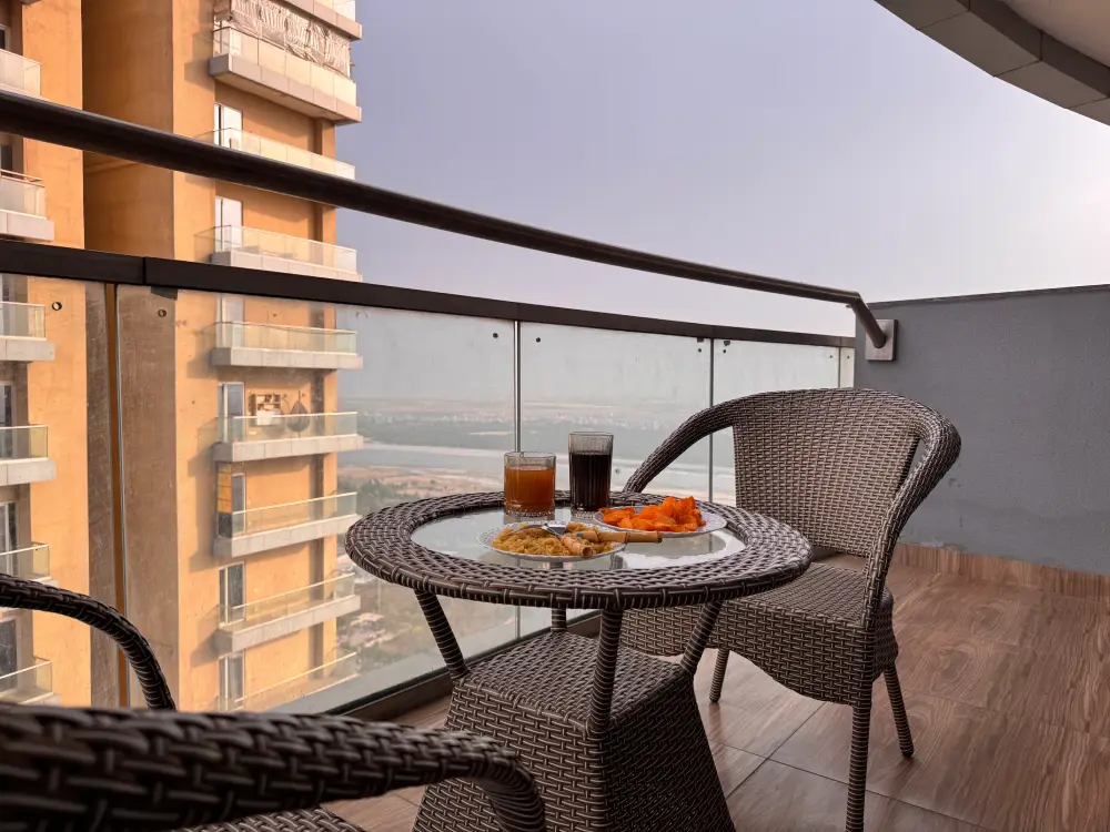 Balcony seating with city view at Spira Noida Airbnb Mulberry Homes