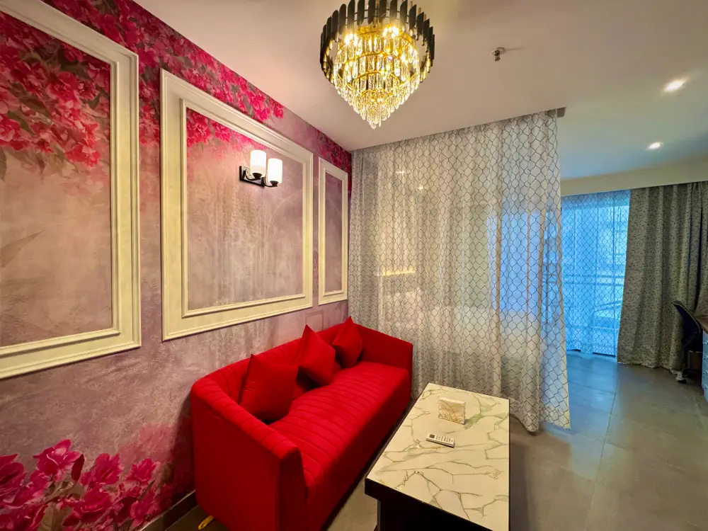 Red theme luxury bedroom at Spira Noida Airbnb Mulberry Homes