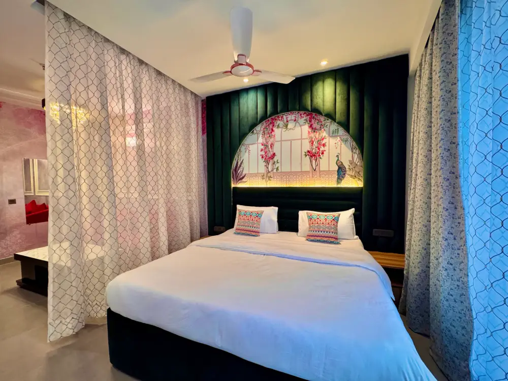 Bedroom with large window view at Supernova Noida Mulberry Homes