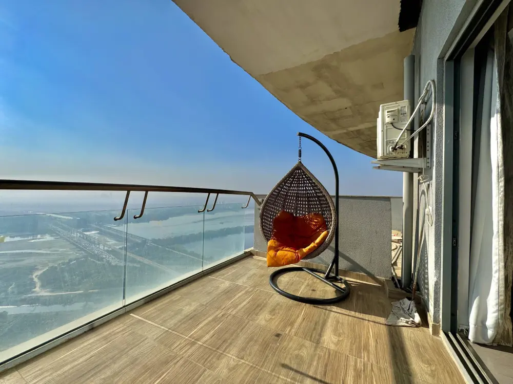 Private balcony lounge at SkyRiver 43 with Yamuna river view in Supernova Noida