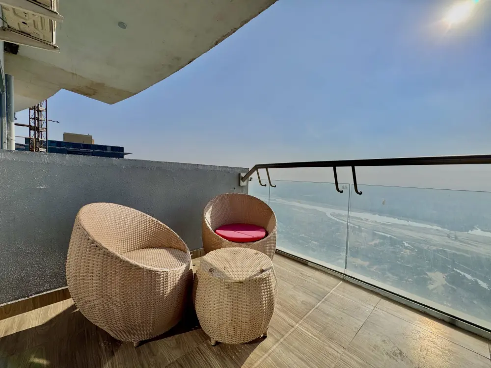 Balcony city and river view from SkyRiver 43 apartment in Supernova Noida