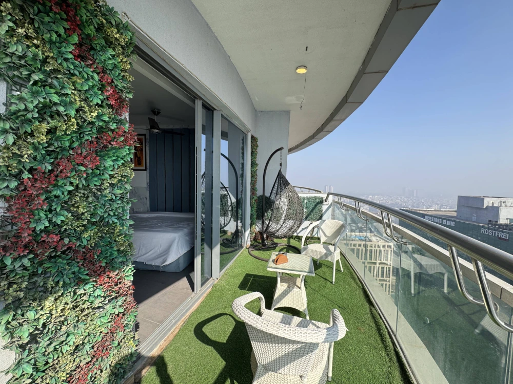 Green balcony setup in Airbnb Supernova Spira apartment by MulberryHomes