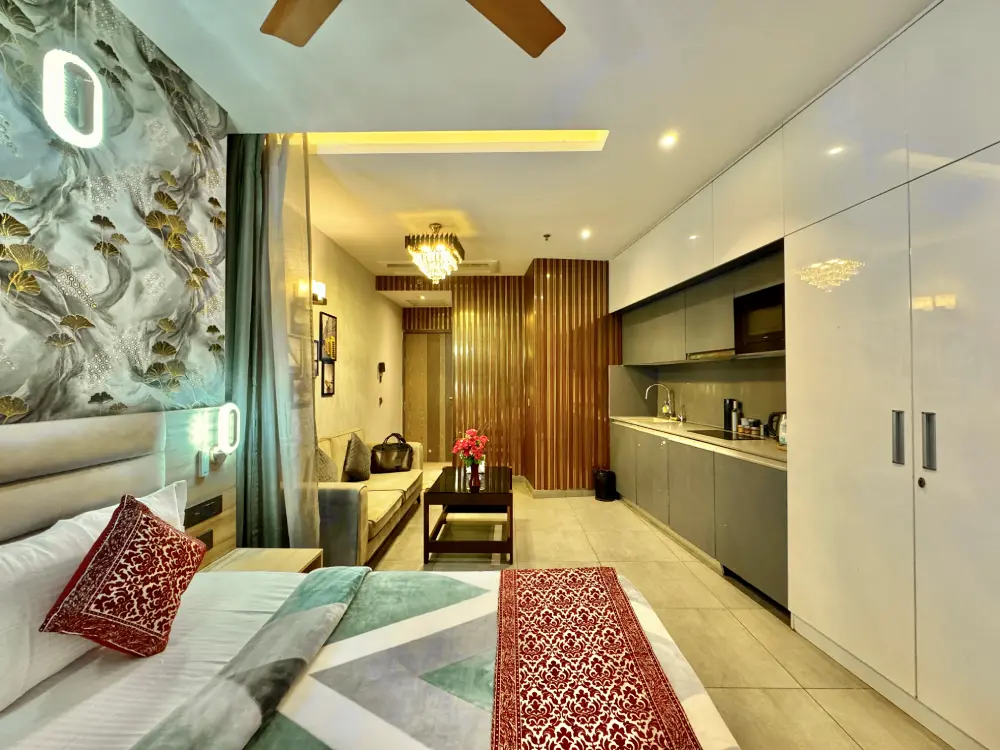 Luxury bed with cushions in UrbanAura 37 Supernova Noida studio apartment